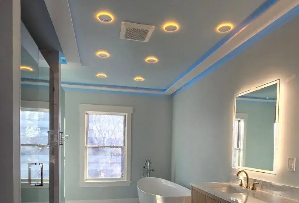 Elegant bathroom ceiling featuring custom crown molding with ambient LED lighting