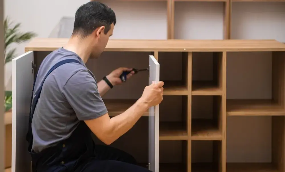 Carpenter assembling custom wooden cabinet doors