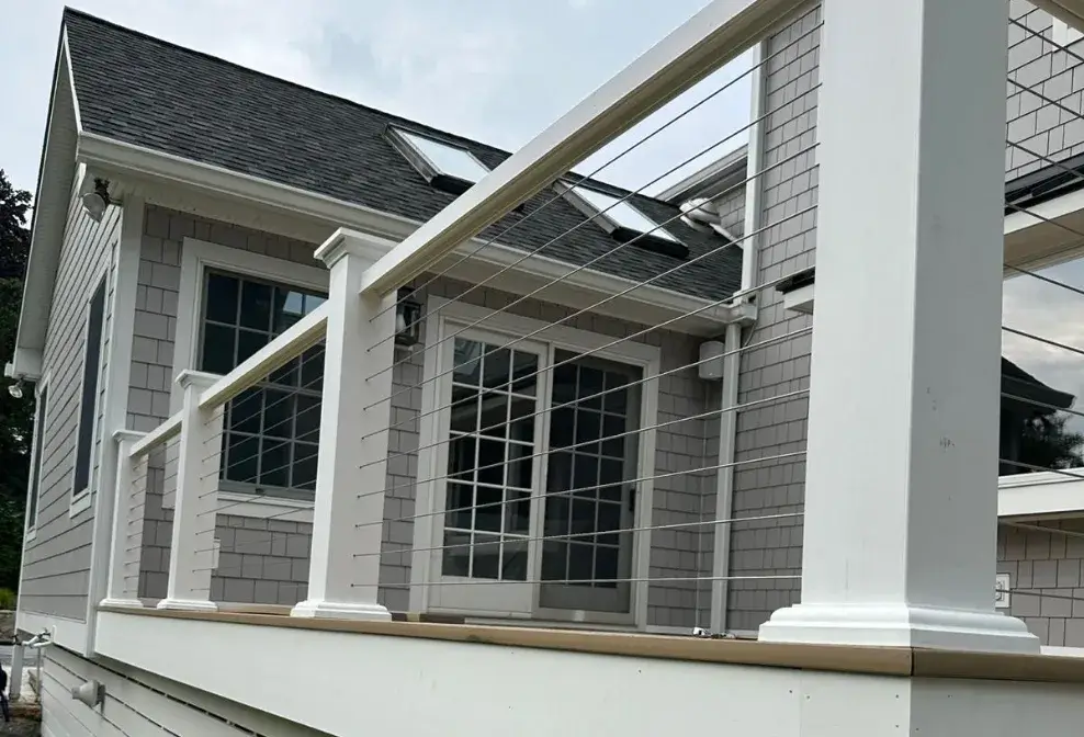 Modern exterior deck with white railing and horizontal cable wires