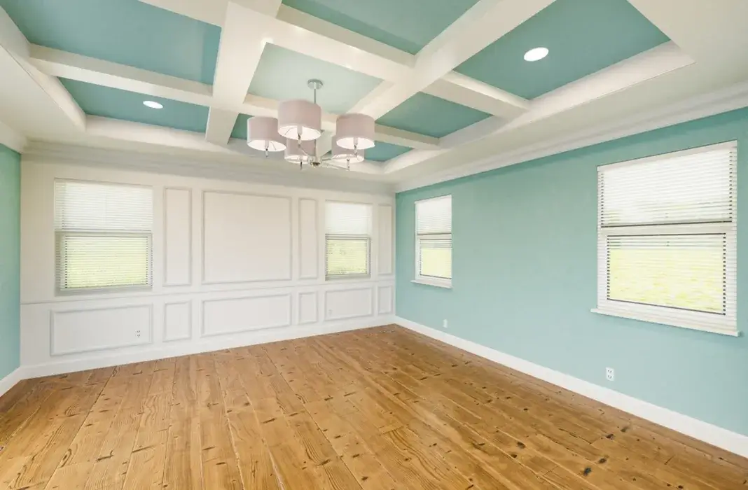 Elegant room with raised panel wainscoting and coffered ceiling