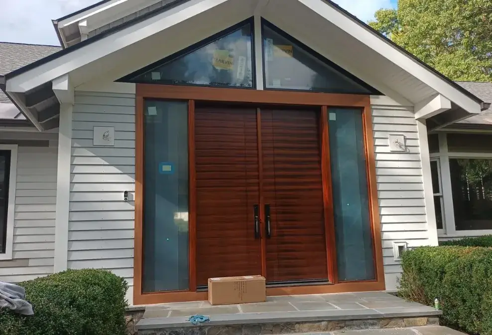 Modern entry door with detailed trim and wood frame